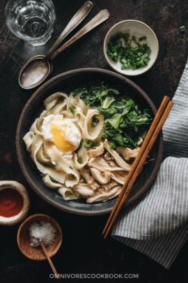 One bowl of Instant Pot chicken noodle soup with Sriracha and salt on the side