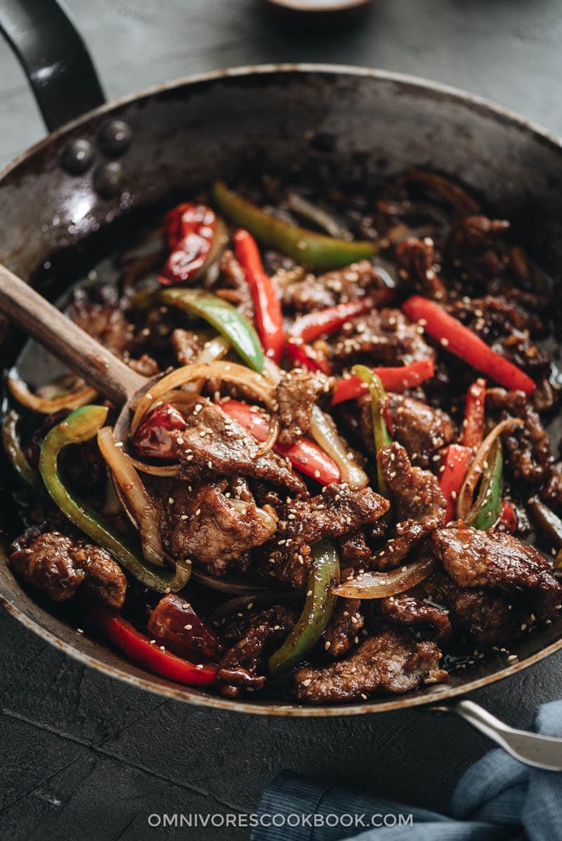 Szechuan beef stir fry served in a plate with rice