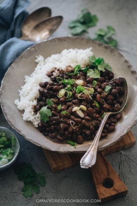 Black beans with rice garnished with cilantro and green onions