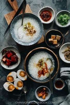 Plain congee topped with pickles, sesame oil and green onion