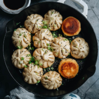 Try this recipe for sheng jian bao (Shanghai pan fried buns) - super juicy and incredibly flavorful pork stuffed into a fluffy yet crispy pan-fried wrapper that satisfies on every level.