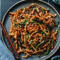 Shredded pork with garlic sauce, or Yu Xiang Rou Si, features tender pork strips stir fried with an array of colorful vegetables, brought together with a rich sauce that is sweet, sour, savory and spicy. Try this dish for an authentic Chinese restaurant experience in your own kitchen!