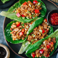 A super easy and fast San Choy Bow, or pork lettuce wrap recipe, that features tender pork and crisp vegetables brought together with a scrumptious brown sauce served on lettuce leaves. Make a light healthy meal or complete your Chinese dinner with this colorful dish! {Gluten-Free adaptable}