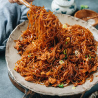 Ma Yi Shang Shu, or stir fried vermicelli with pork, is a perfect quick weekday dinner dish that is so flavorful yet easy to put together. A Sichuan classic, it features tender mung bean vermicelli noodles braised in a savory aromatic sauce with ground pork, spiced up with chili bean paste. All you need is 20 minutes to put it together - top it on a bowl of steamed rice for a great dinner! {Gluten-Free Adaptable}