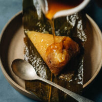 These alkaline dumplings (碱水粽子, Jian Shui Zong Zi) are extra tender and gooey, filled with red bean paste and has a heavenly earthy fragrance. I included detailed step-by-step photos and a video to help you make the perfect zongzi to celebrate the Dragon Boat Festival! {Gluten-Free, Vegan}