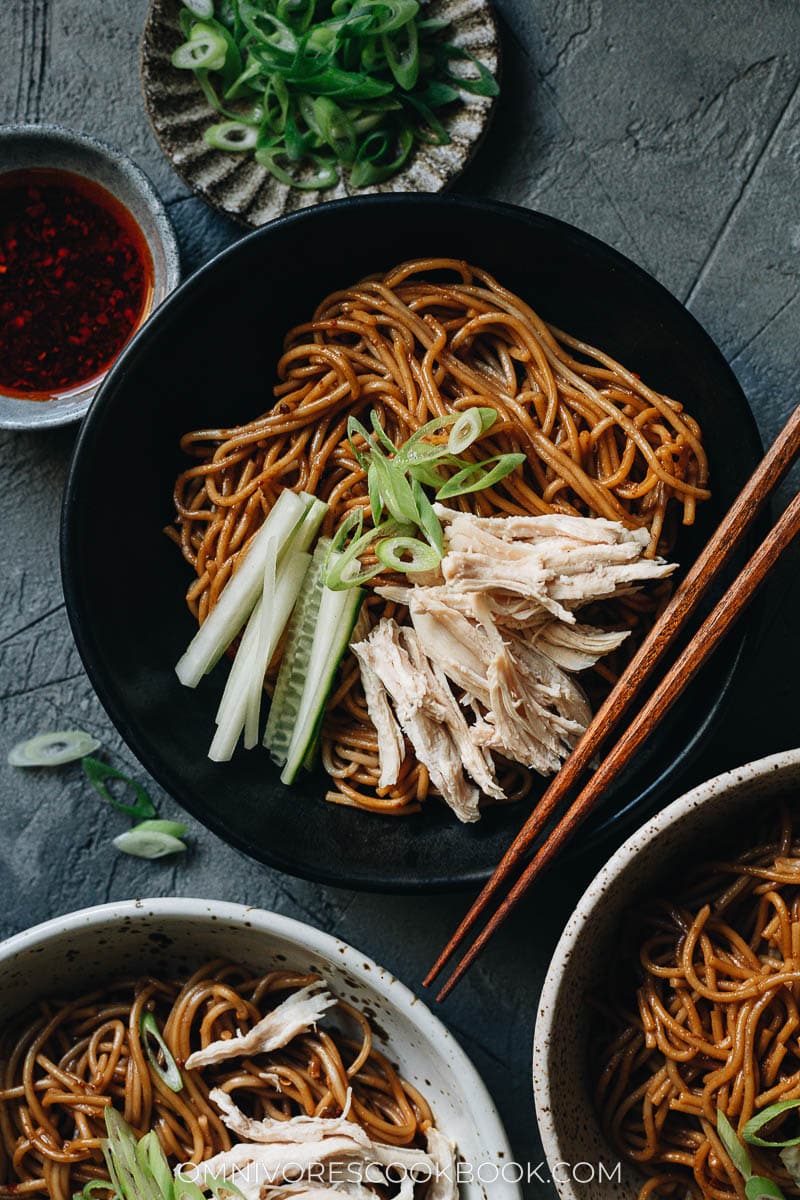 Chinese chicken noodle salad served in small bowls with chili oil on the side