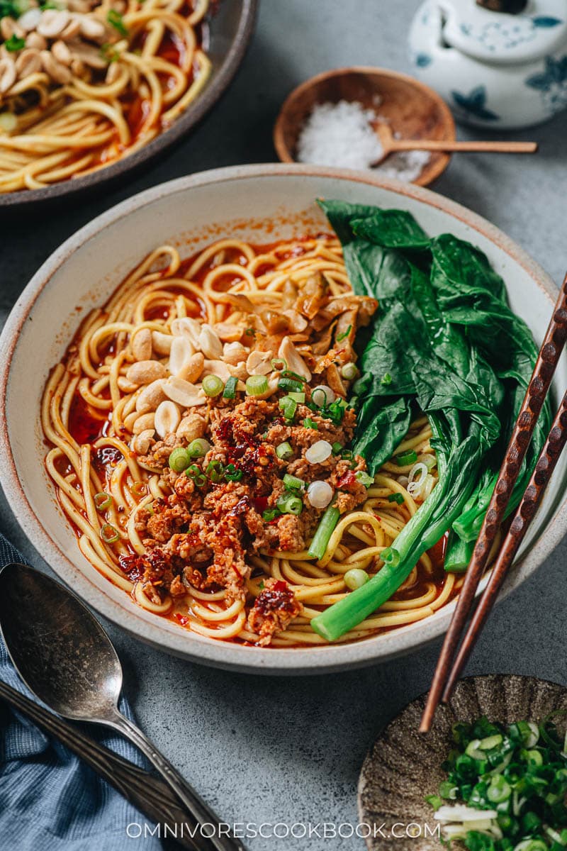 Chongqing noodles topped with pork, yu choy and peanuts