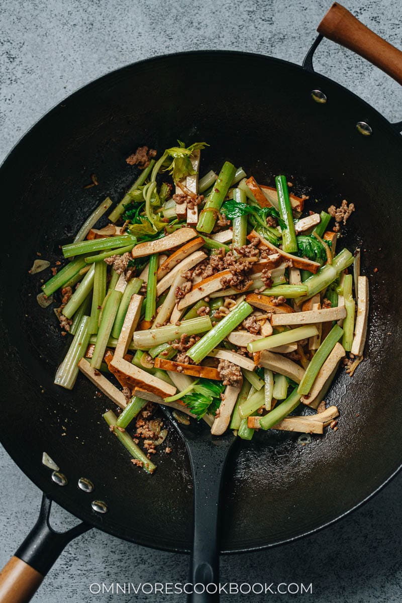 Dried tofu and celery stir fry in a wok