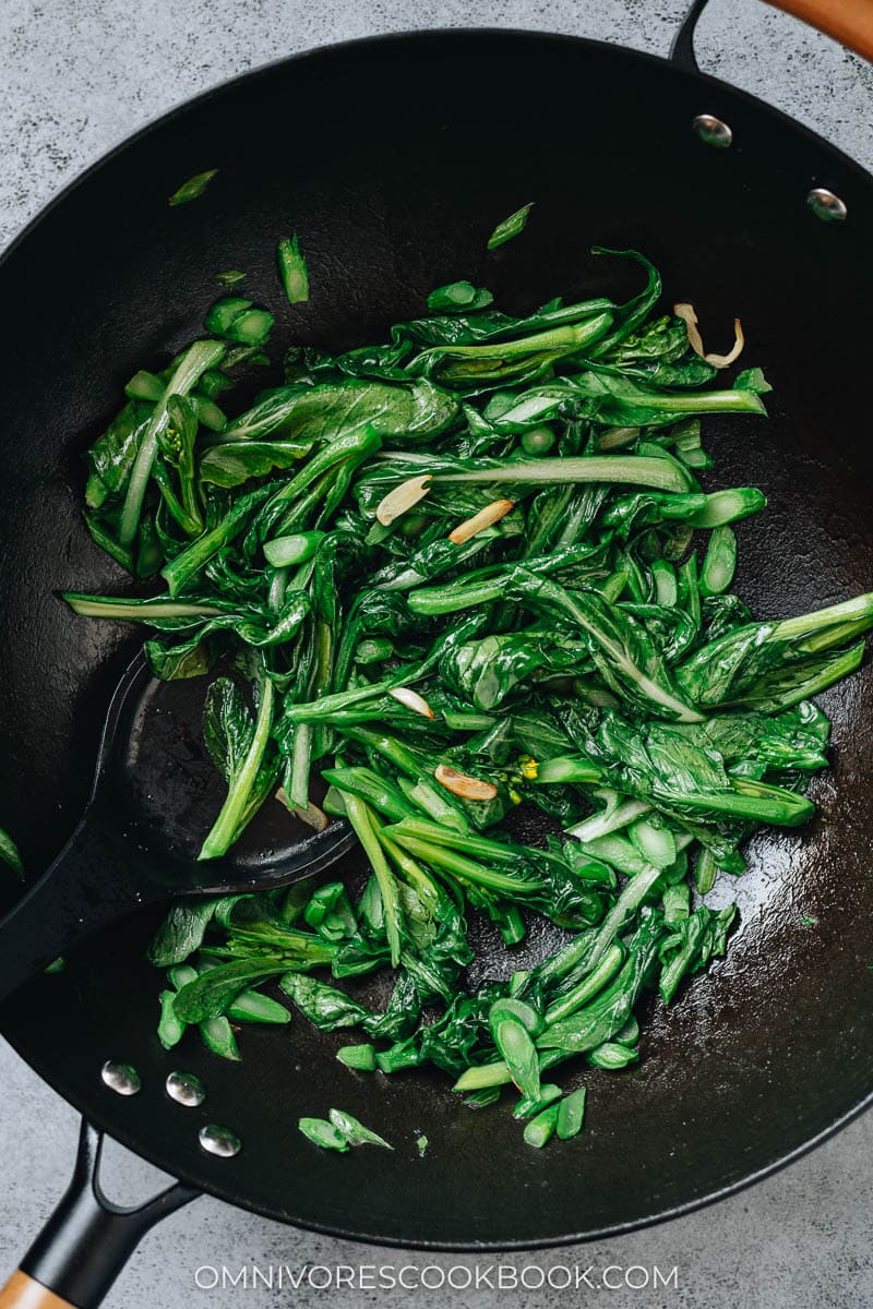 Yu choy stir fry in a wok